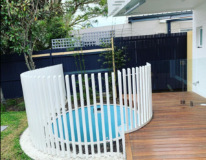 white blade pool fencing installed around a round pool