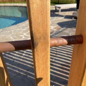 cloes up of copper and wood fence showing copper strafes and wooden vertical poles